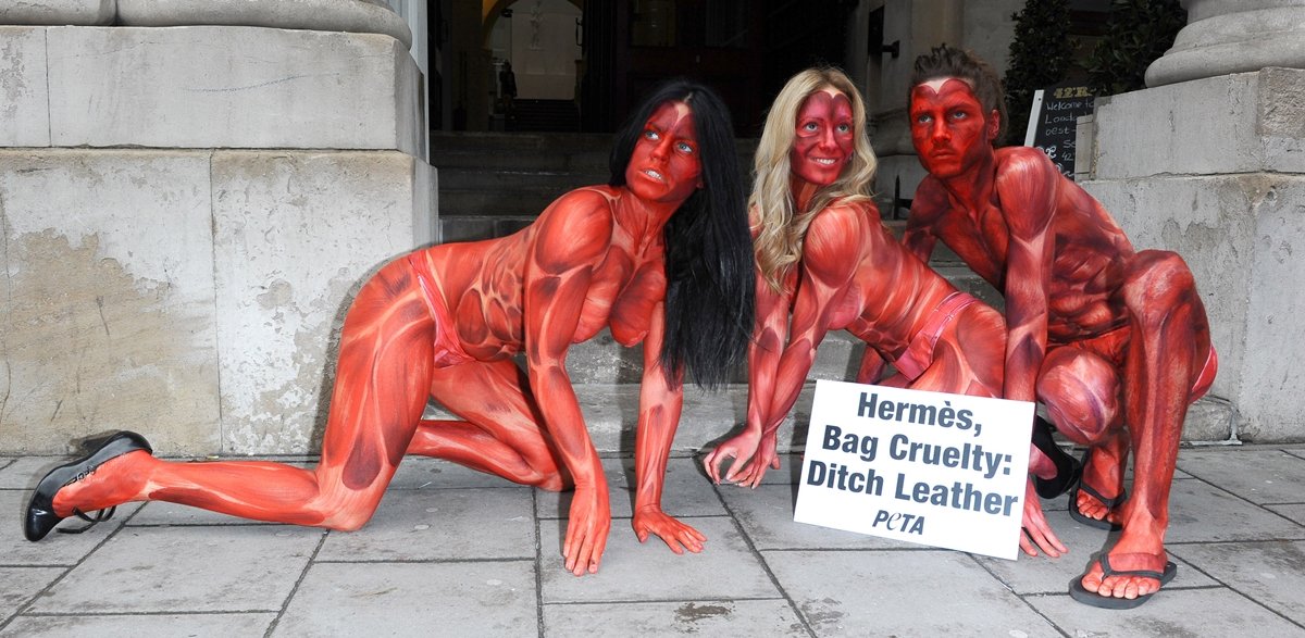 Painted to resemble bloodied and skinned people, three models representing PETA converged outside the opening of the "Hermes Leather Forever" exhibition at the Royal Academy of Arts at Burlington Gardens