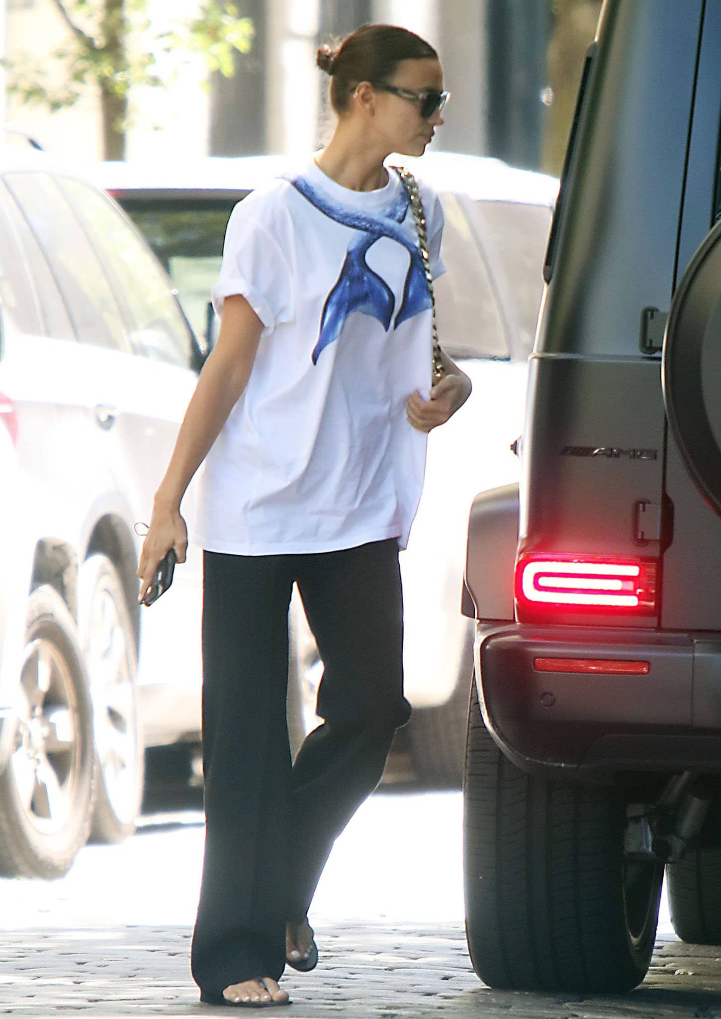 Irina Shayk keeps things casual in Burberry mermaid tail-print white tee and black pants