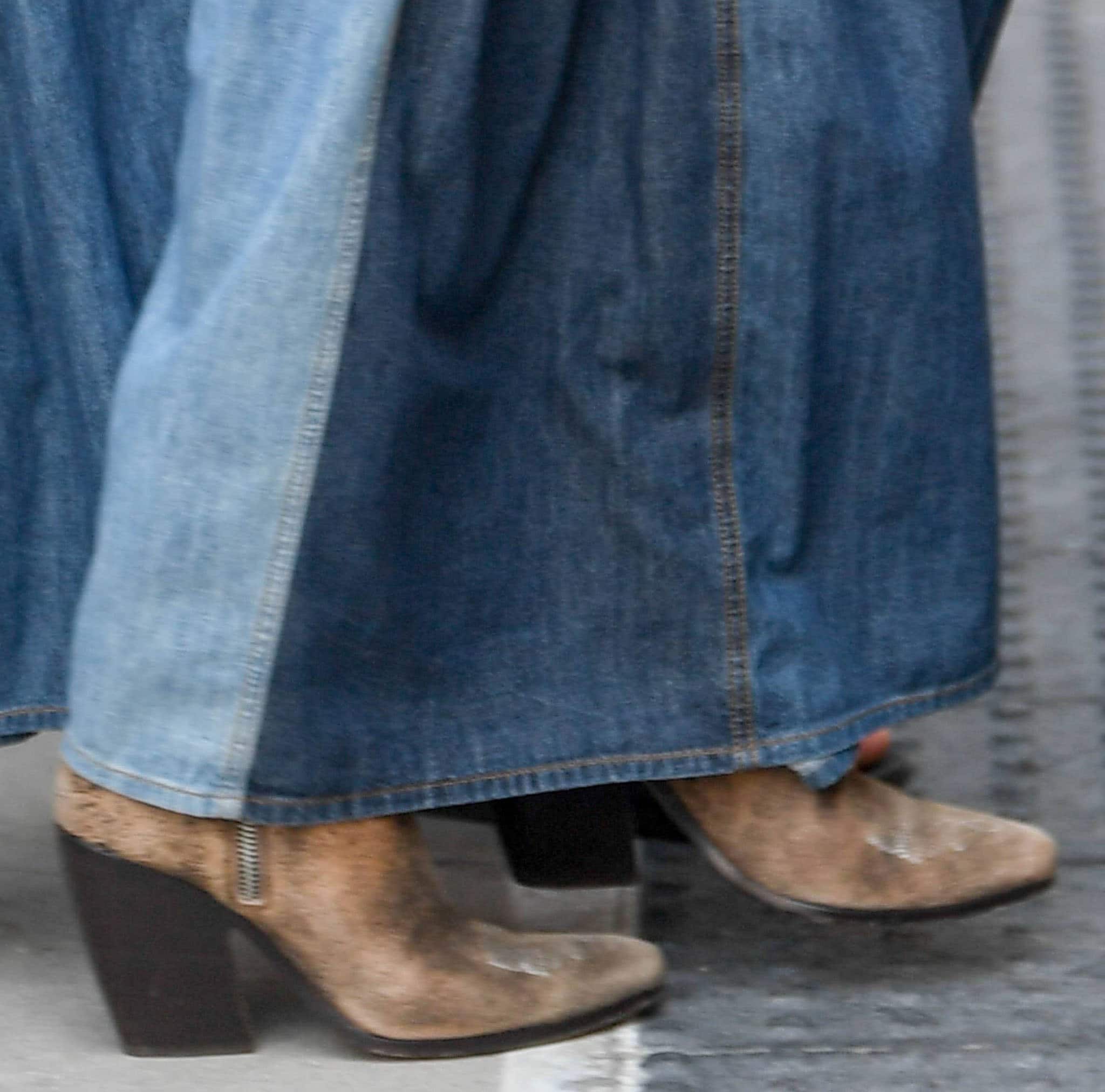 Jennifer Lopez teams her denim maxi skirt with Ralph Lauren distressed cowboy boots