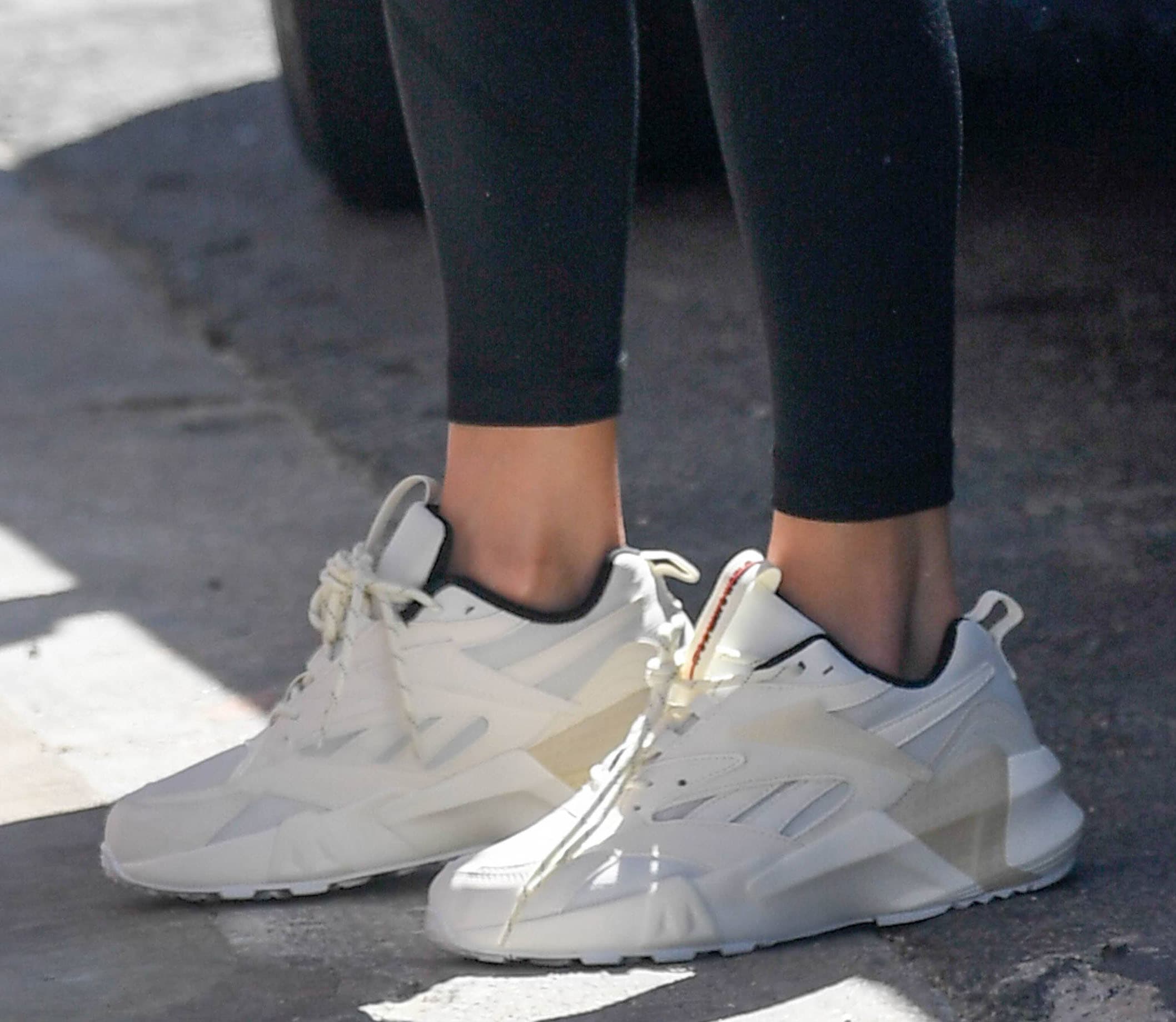 Jennifer Lopez completes her athletic outfit with Reebok Aztrek Man's World chunky white sneakers