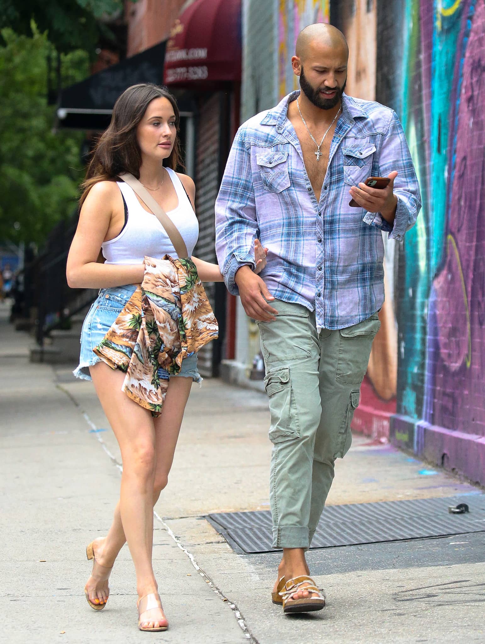 Kacey Musgraves looks hot in white tank top and daisy dukes on a dinner date with Cole Schafer on June 18, 2021