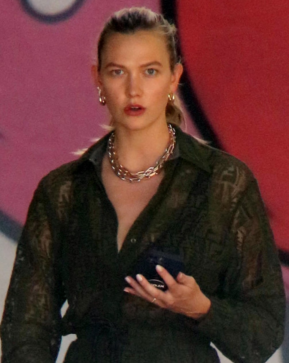 Karlie Kloss ties her hair into a high ponytail and accessorizes with Melissa Kaye earrings and Briony Raymond New York necklace