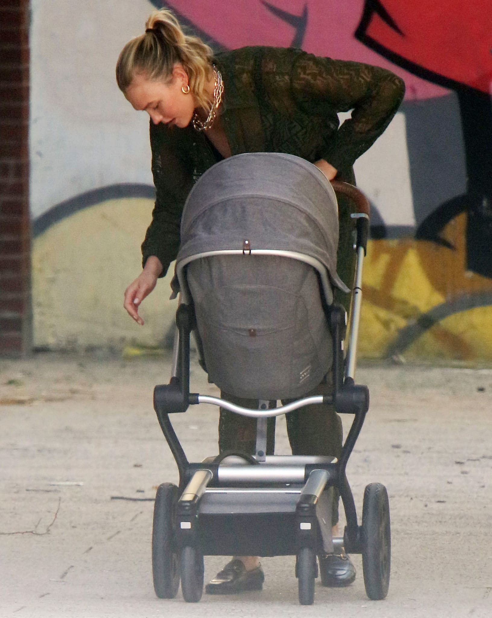 Karlie Kloss pairs her green sheer Fendi jumpsuit with black Gucci loafers