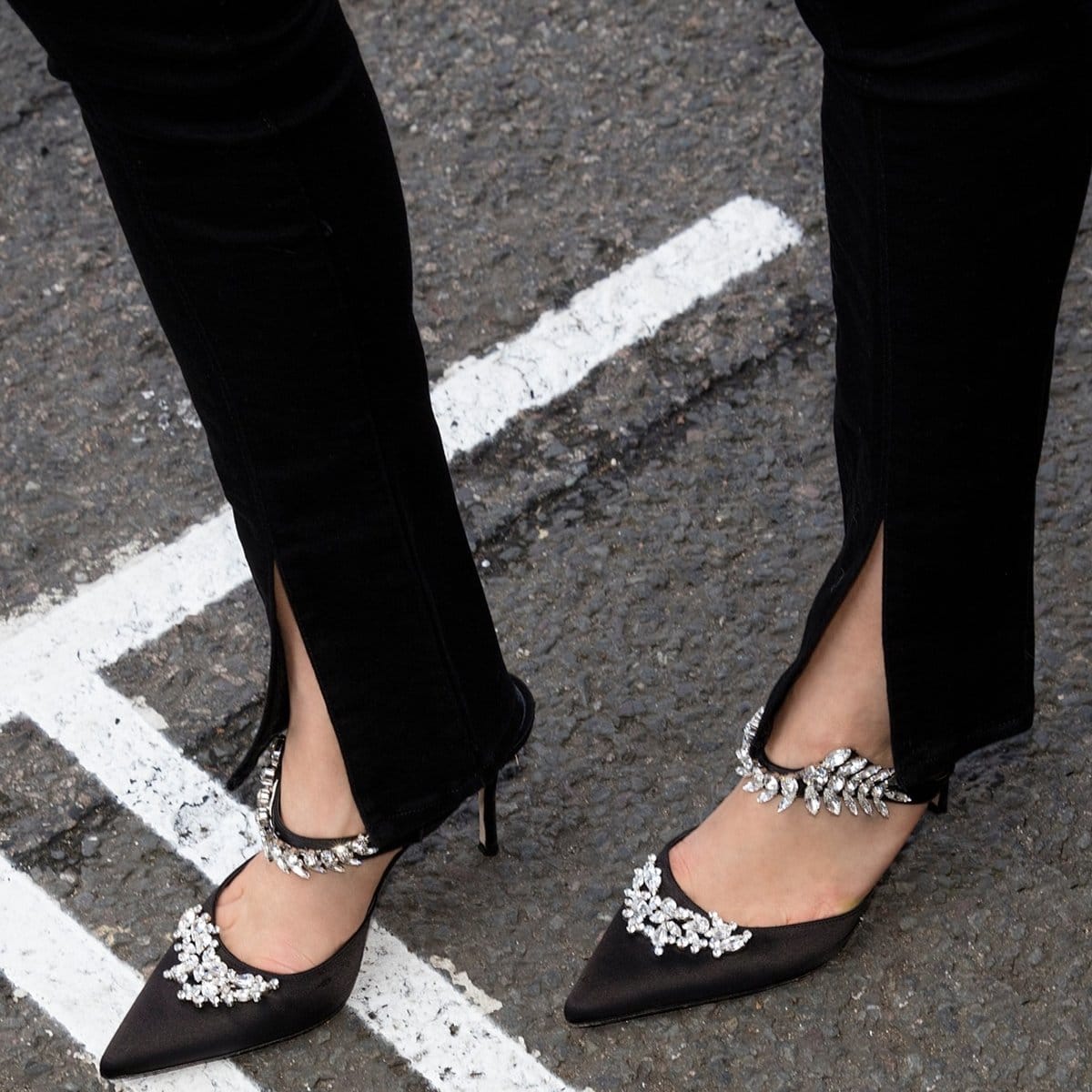 Sparkling crystal leaves vine across this pointy-toe satin pump, showcasing Manolo Blahnik's flair for dramatic embellishment