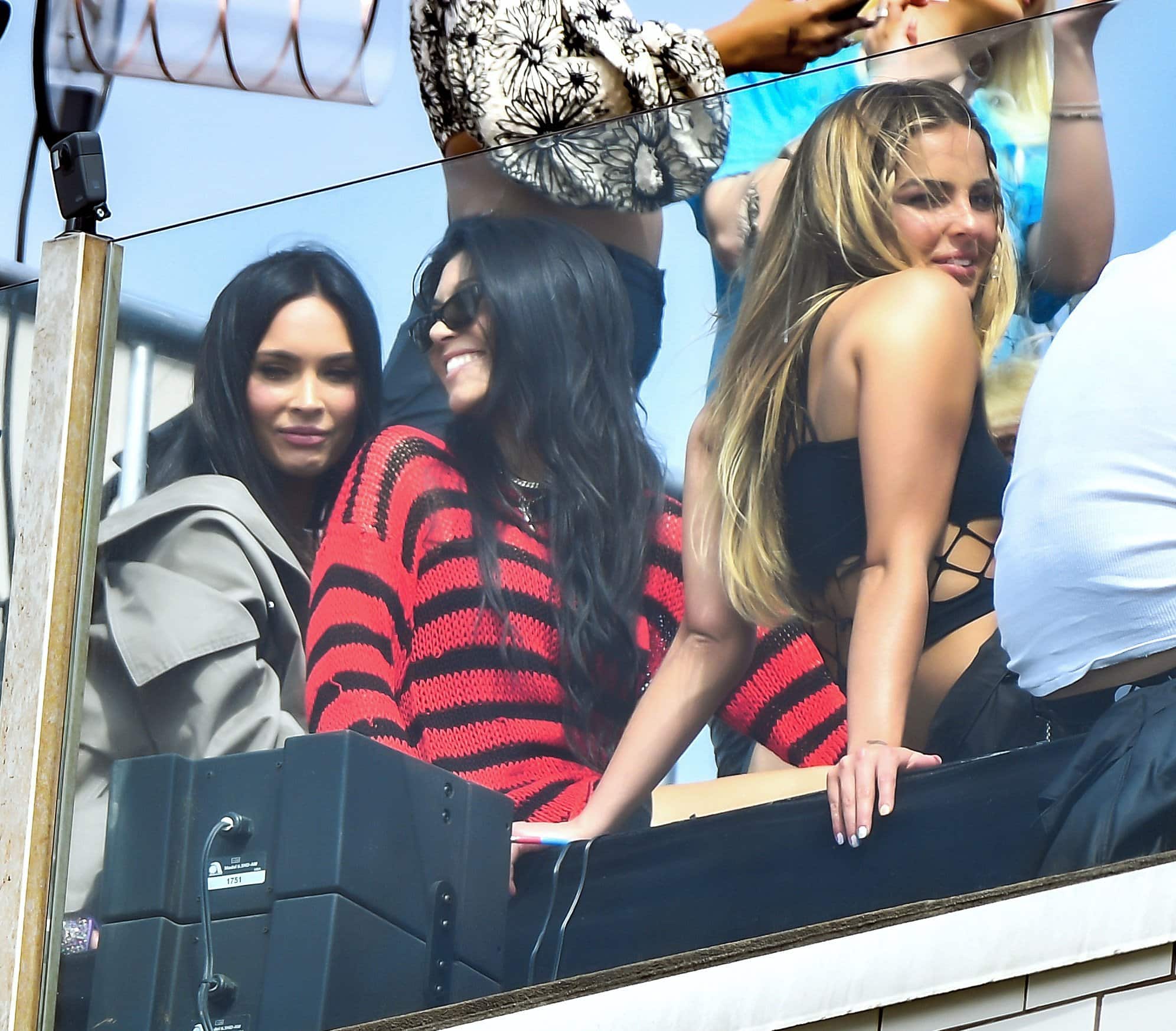 Megan Fox and Kourtney Kardashian show support for their boyfriend's rooftop concert with Addison Rae