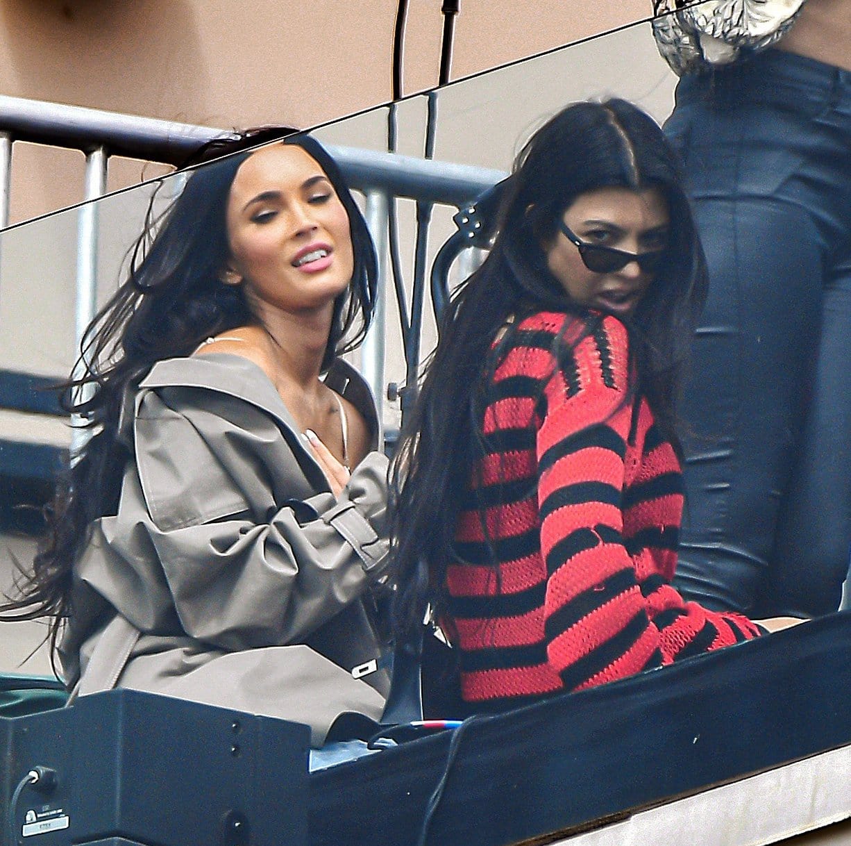 Kourtney Kardashian teams her red and black Raf Simons sweater with Prada chunky boots