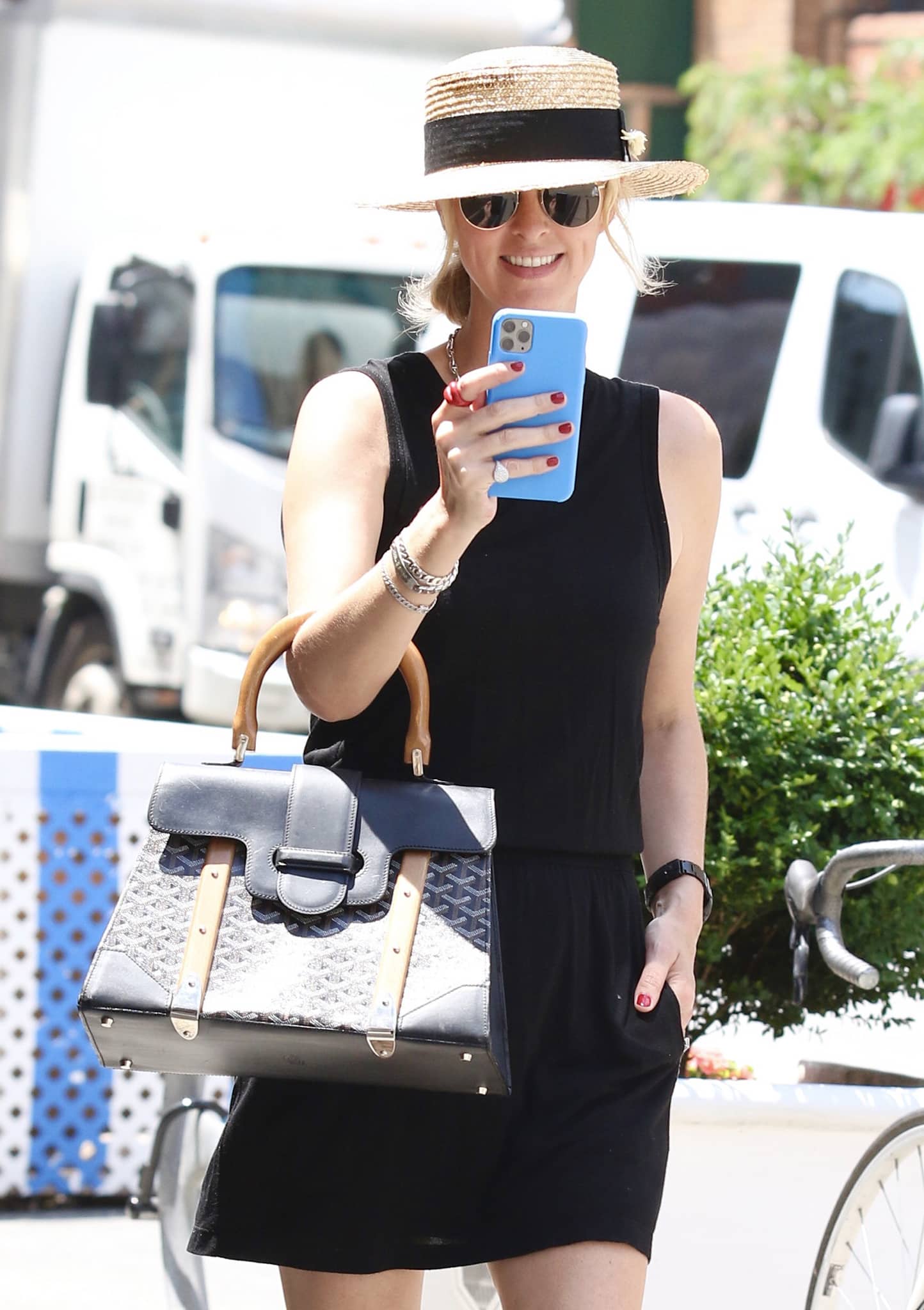 Nicky Hilton styles her summer outfit with a straw hat and a Goyard Saigon bag