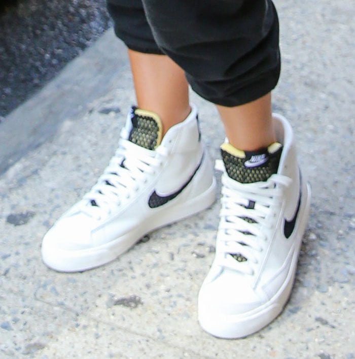 Olivia Culpo completes her sporty gym look with Nike Blazer Mid sneakers with black and neon green mesh tongues