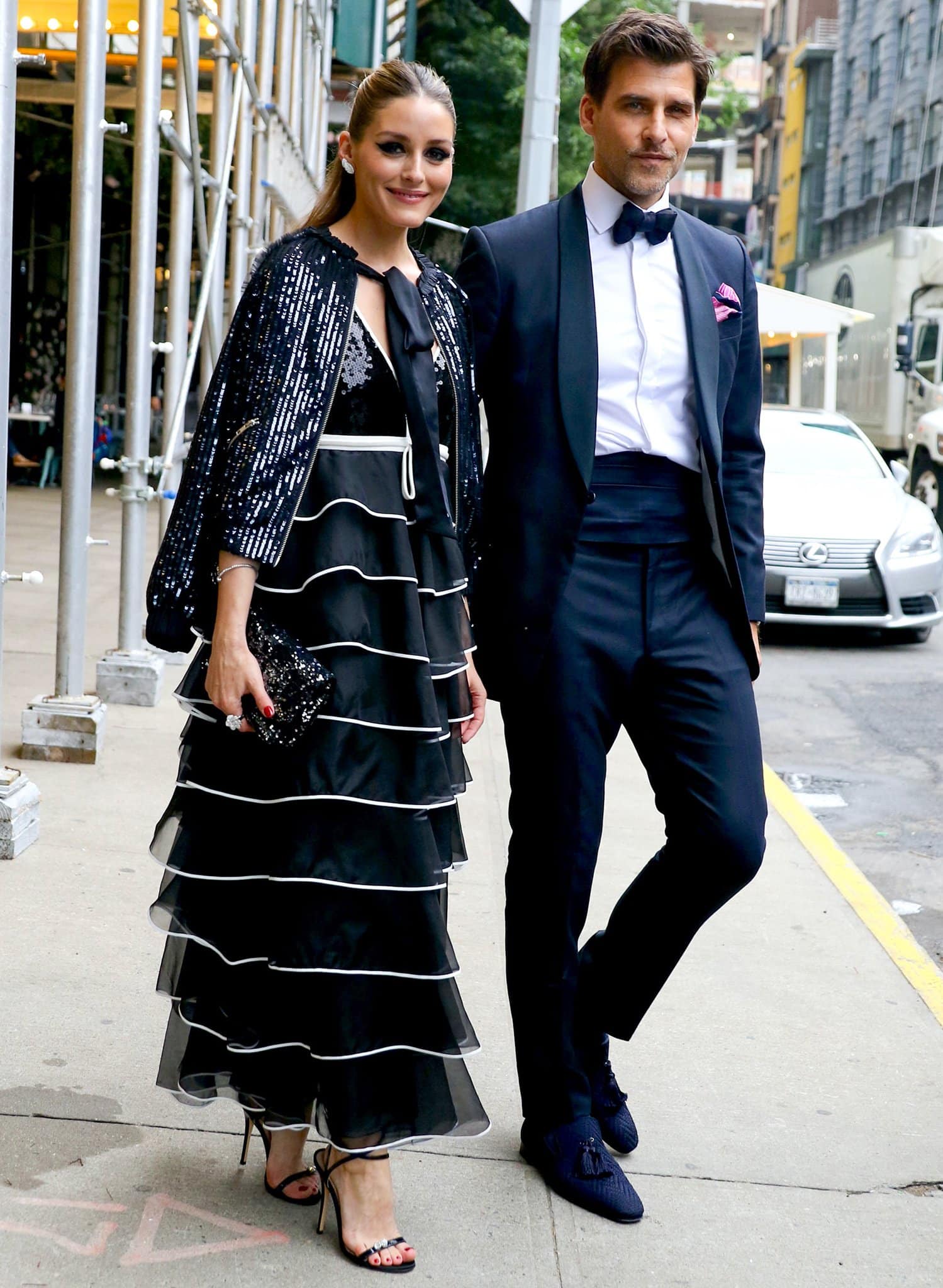 Olivia Palermo stuns in a Giambattista Valli tiered ruffled dress and a sequined jacket while Johannes Huebl looks handsome in a black suit with a bowtie