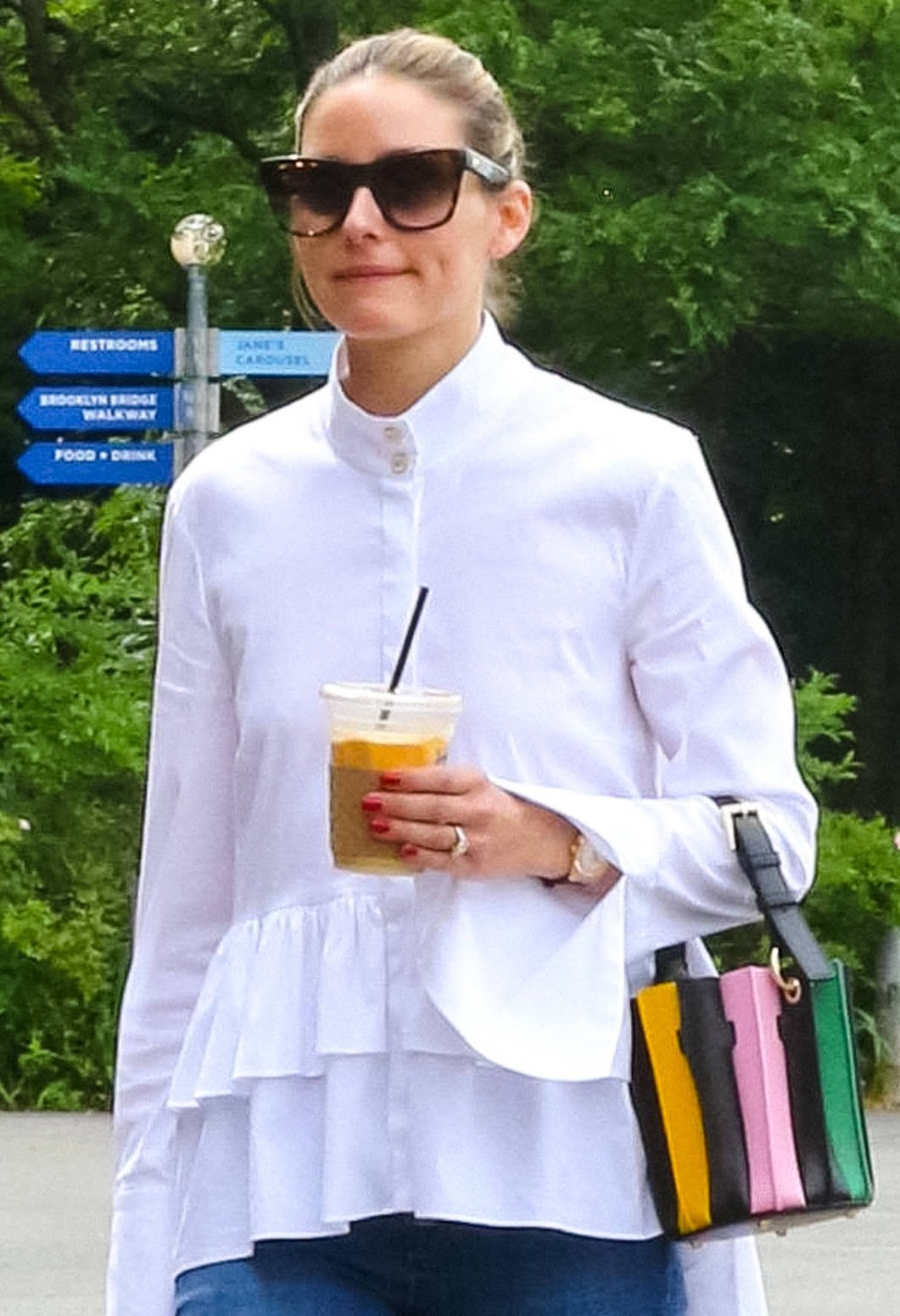 Olivia Palermo pulls her tresses back into a neat bun and carries a colorful striped mini bucket bag from Sara Battaglia