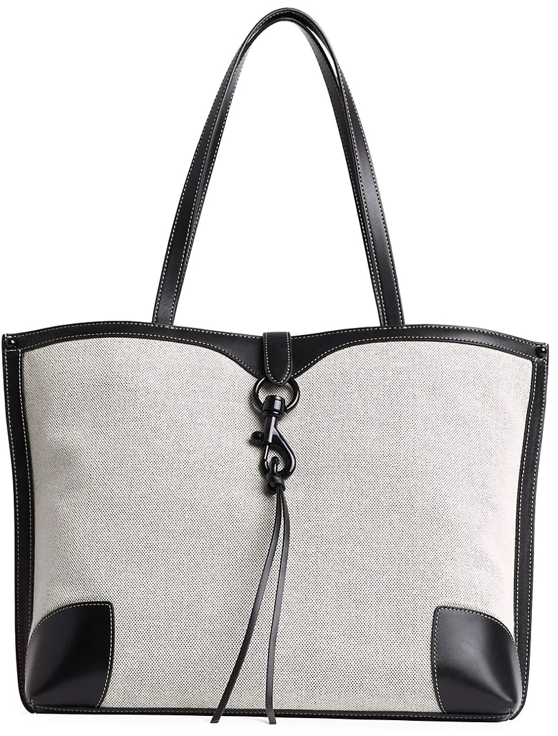 Crafted of rugged canvas with leather-look trim, this classic shopper tote flaunts a utilitarian lobster clip detail