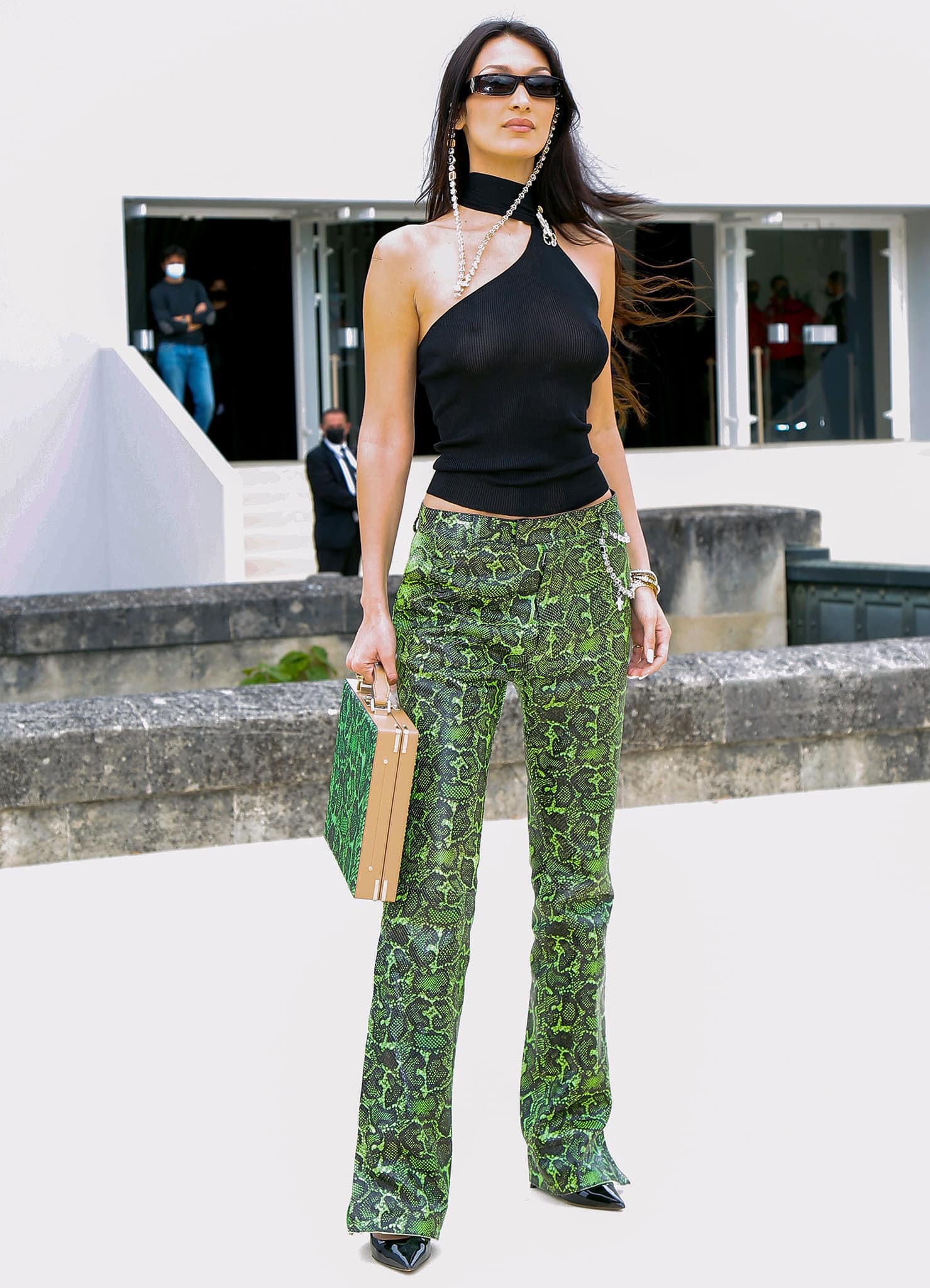 Bella Hadid is braless underneath her Gucci x Tom Ford sheer top paired with Dior green snakeskin trousers