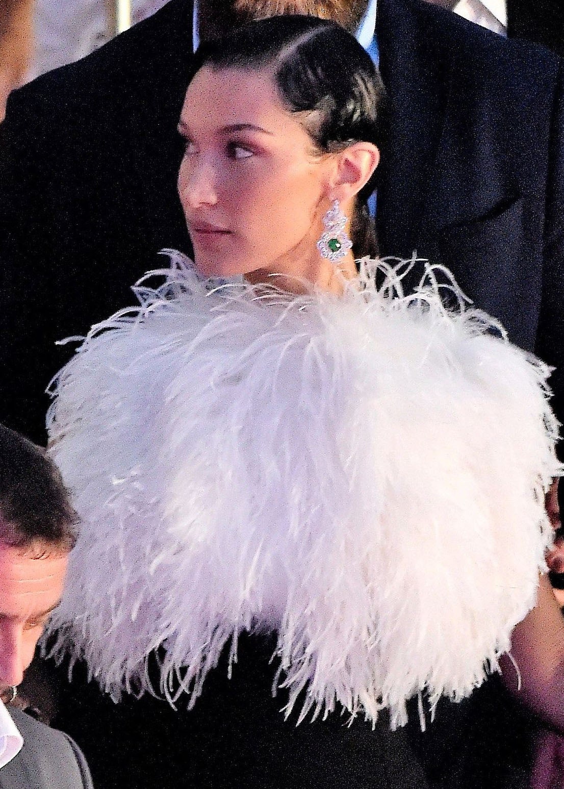 Bella Hadid wears her hair in a ponytail with finger waves and accessorizes with Chopard emerald earrings