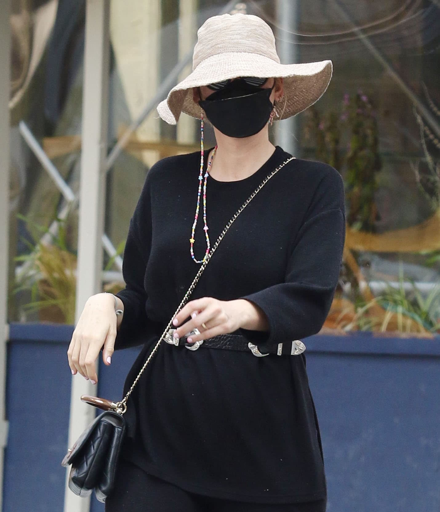 Blake Lively covers her face with David Beckham sunglasses, a black face mask, and a floppy hat