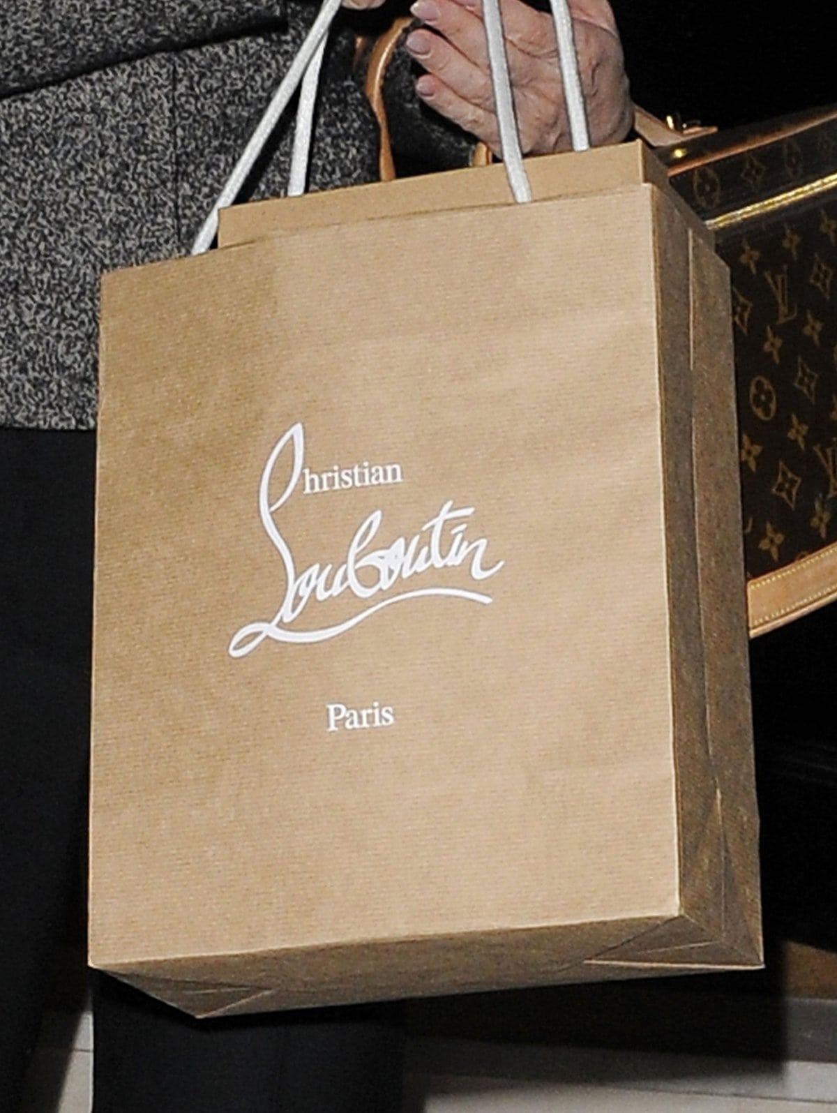 Kelly Brook carries an authentic Christian Louboutin shopping bag