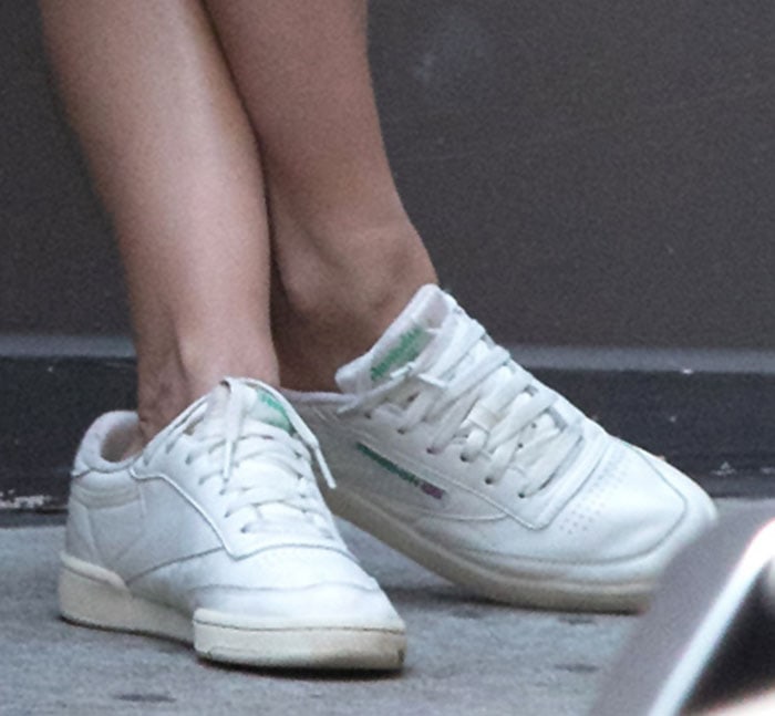 Emily Ratajkowski pairs her mini dress with white Reebok Club C 85 shoes