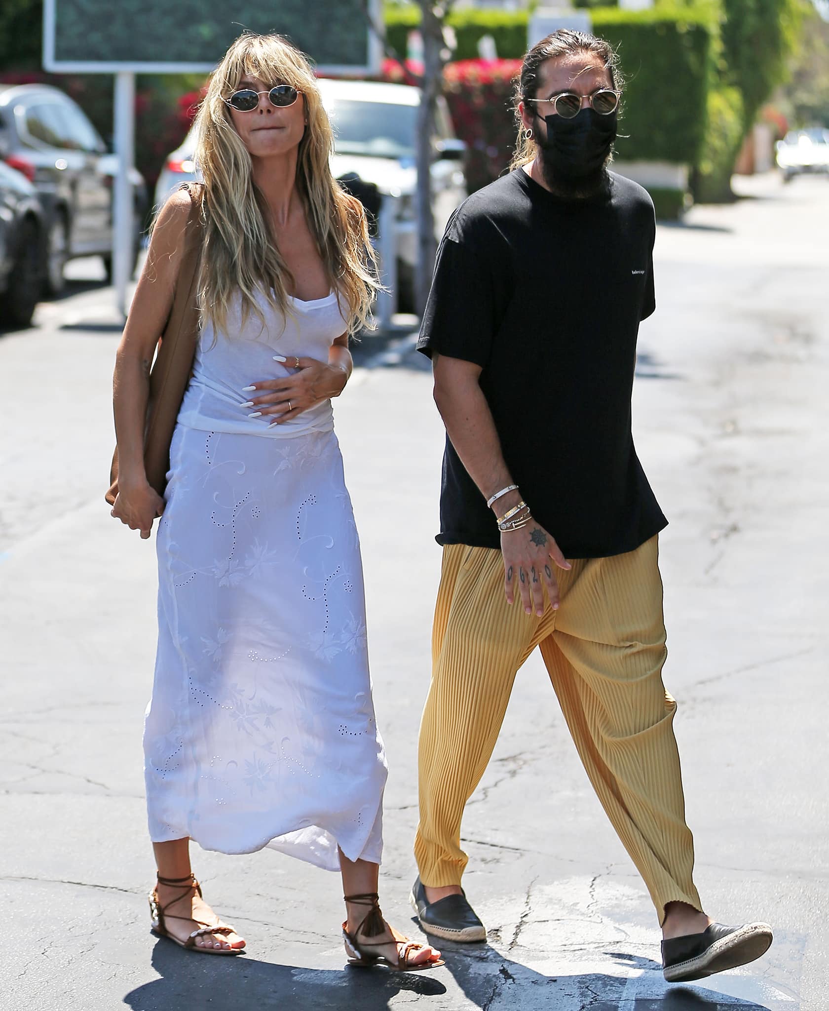 Heidi Klum's husband opts for a casual black tee with yellow pleated pants and espadrille loafers