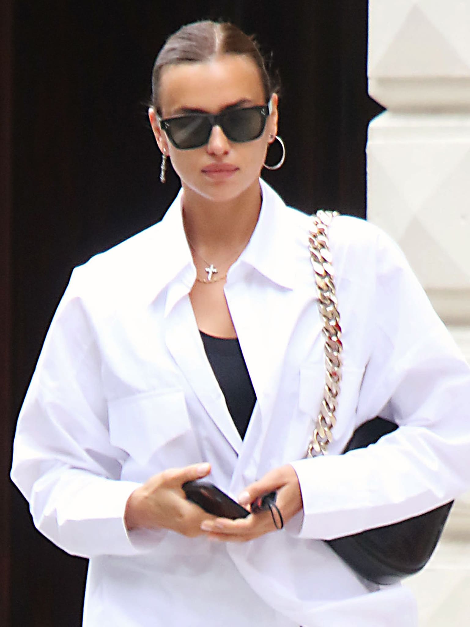 Irina Shayk styles her hair in her signature sleek bun and wears light makeup