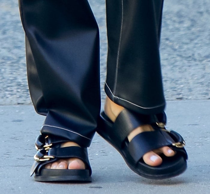 Irina Shayk pairs her leather pants with chunky two-strap sandals