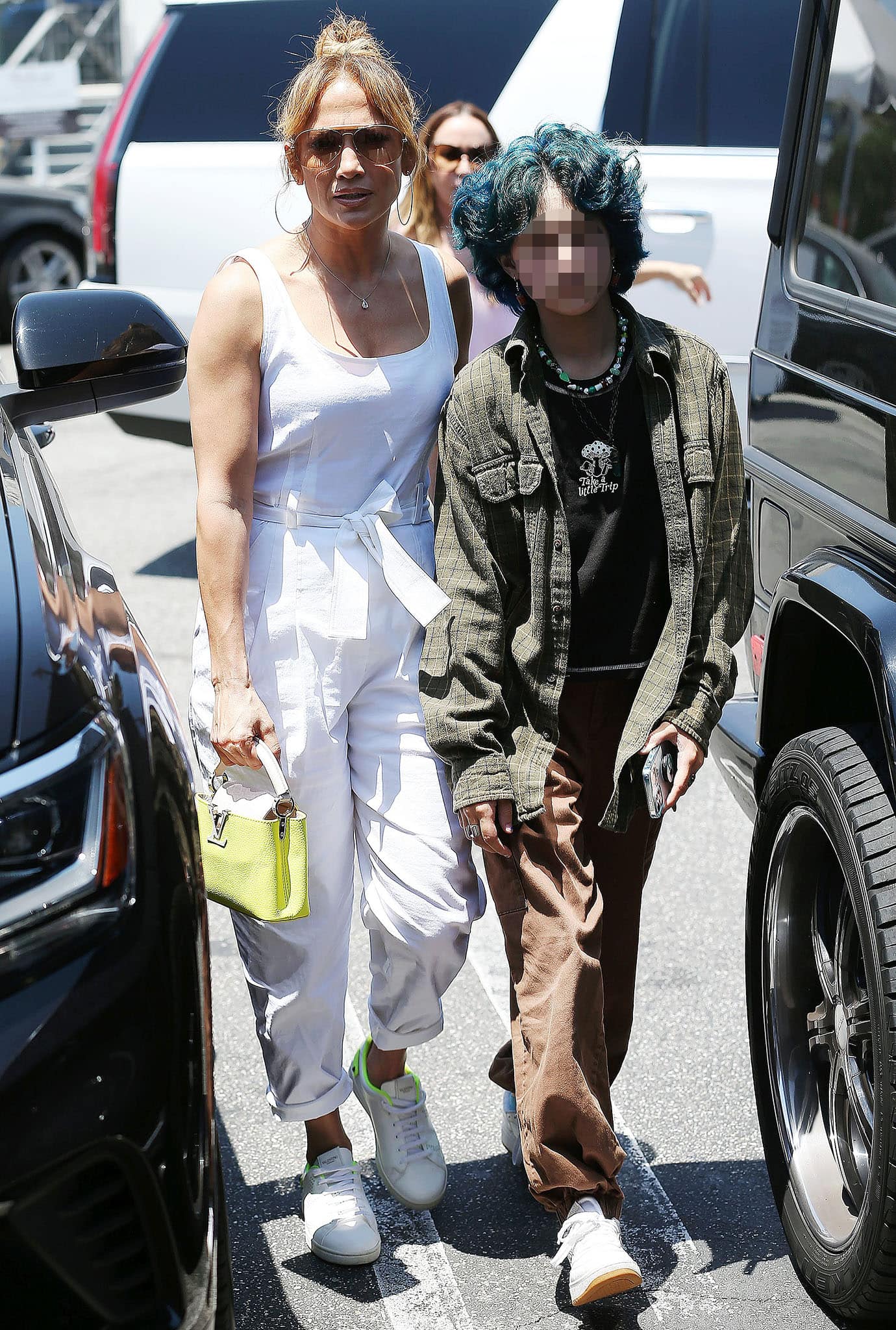 Jennifer Lopez's daughter, Emme, rocks curly green hair with oversized plaid shirt and baggy pants