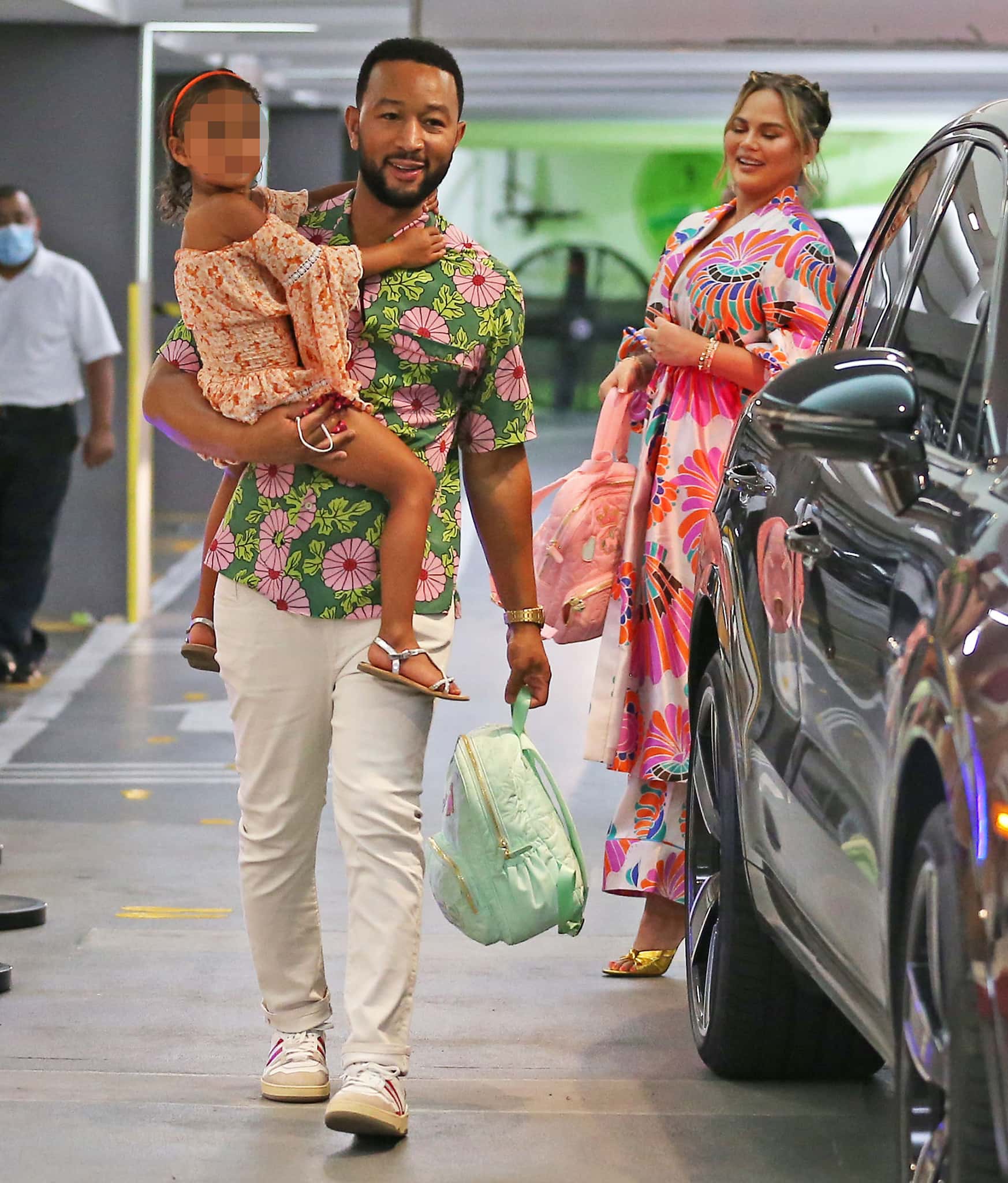 John Legend wears a green Hawaiian shirt as he carries daughter Luna