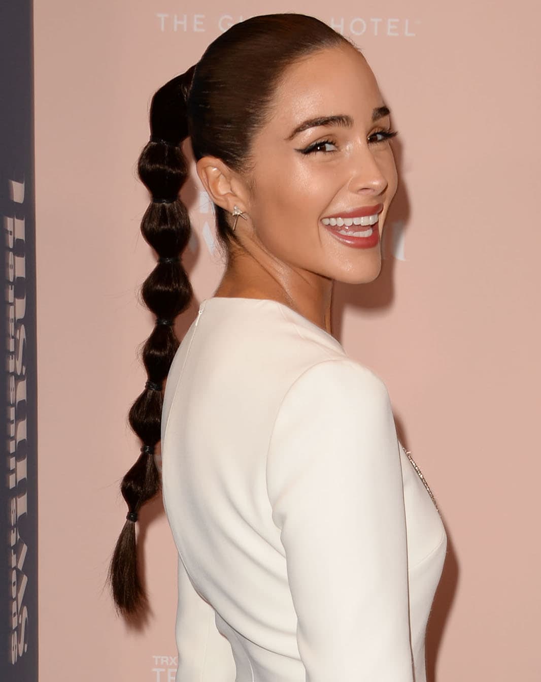 Olivia Culpo wears cat-eyeliner and a bubbly ponytail extension