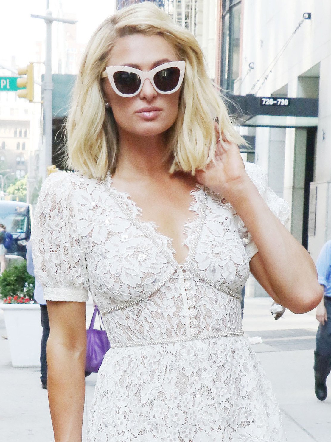 Nicky Hilton wears her bob-cut hair in tousled waves with nude lipstick and retro acetate cat-eye sunglasses