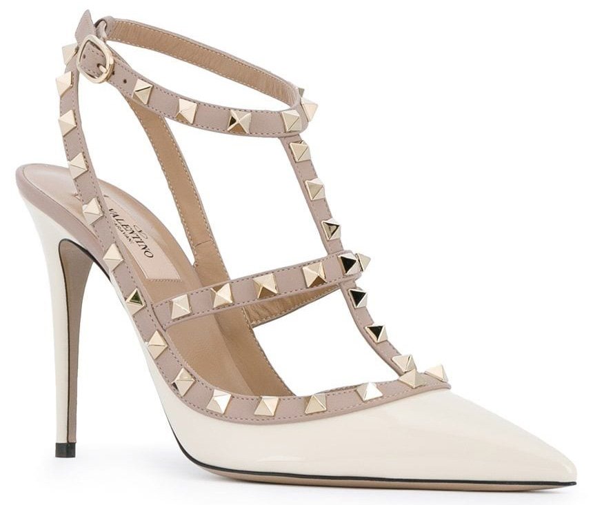 Valentino's signature Rockstud caged pumps in ivory white patent leather with gold-studded beige leather trims