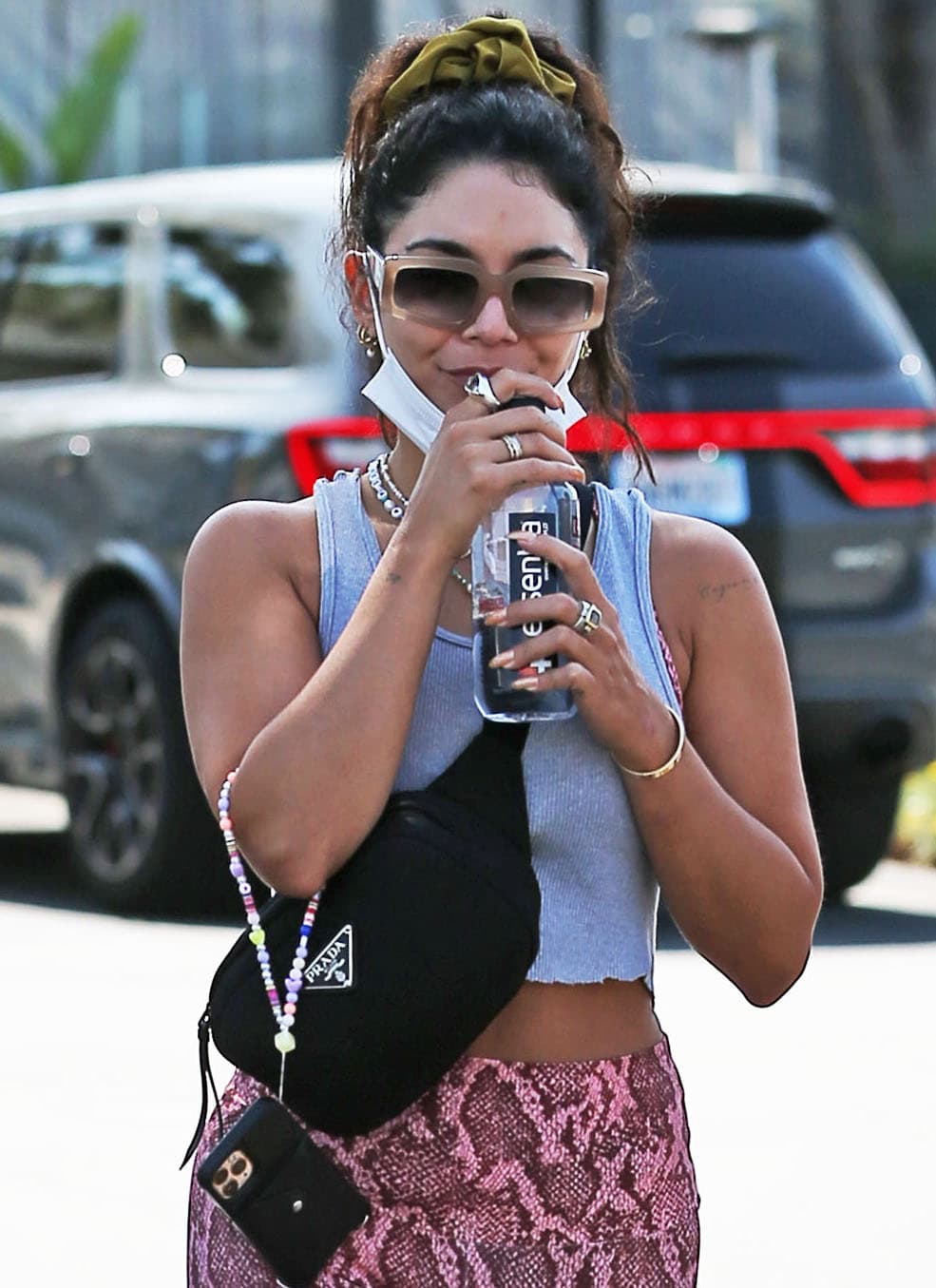 Vanessa Hudgens wears her natural curls up into a ponytail and hides her eyes behind Dezi sunglasses