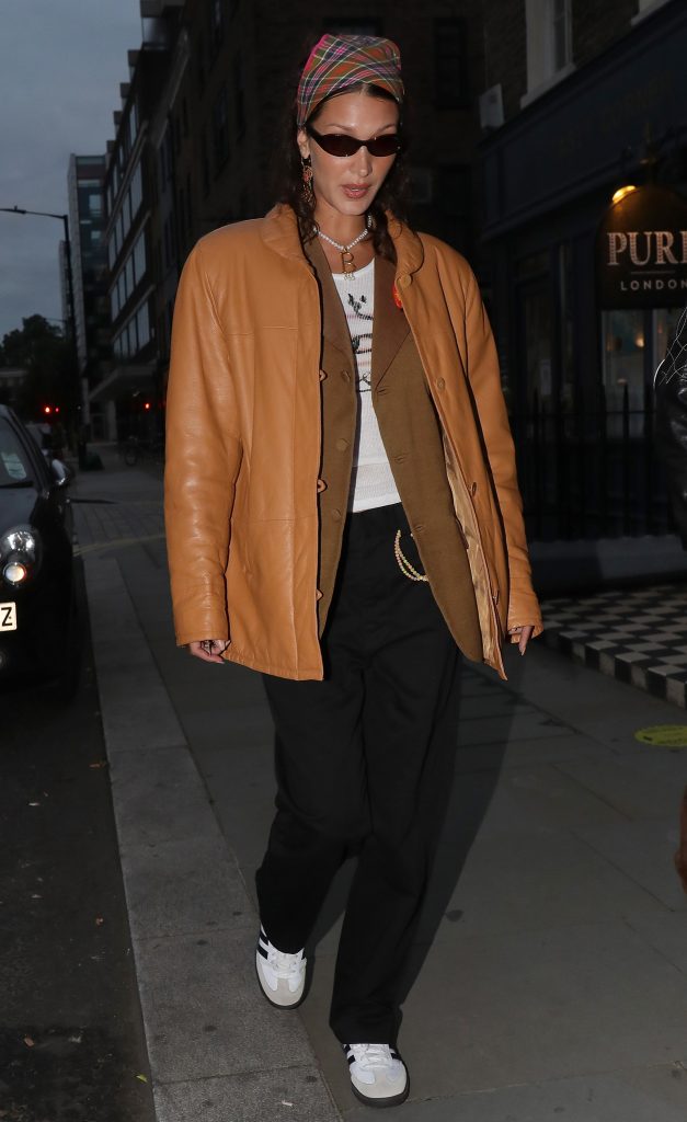 Bella Hadid Shops at Selfridges in Mustard Leather Jacket and Adidas ...