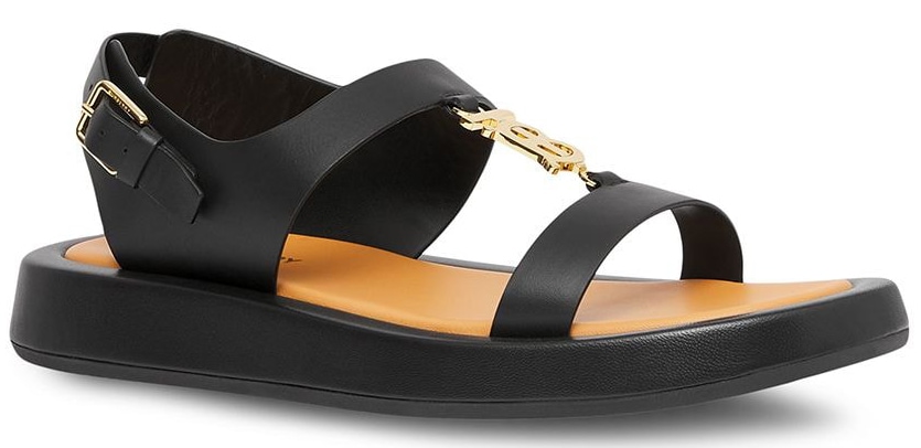 A casual flat sandal that features wide straps, a chunky sole, and Burberry's TB logo plaque