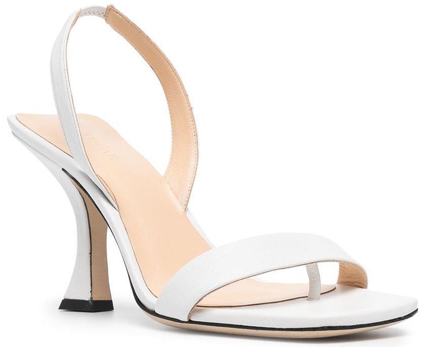 A minimalist pair of white sandals with slingback straps and spool heels