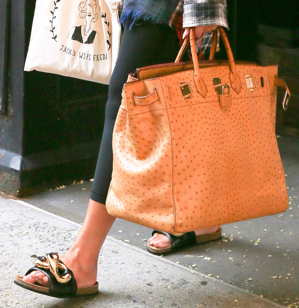 Chrissy Teigen finishes off her laidback outfit with Hermes Birkin bag and JW Anderson Chain slides