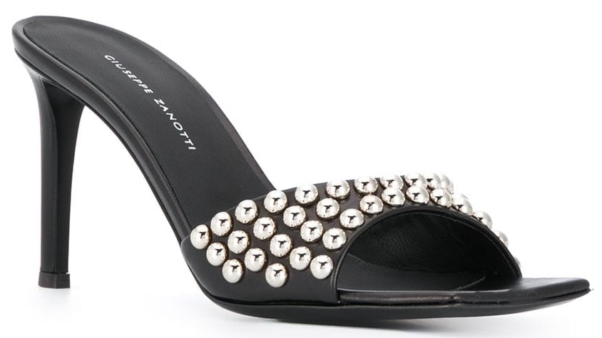 An edgy black mule sandal with stud-embellished open toe straps and mid heels