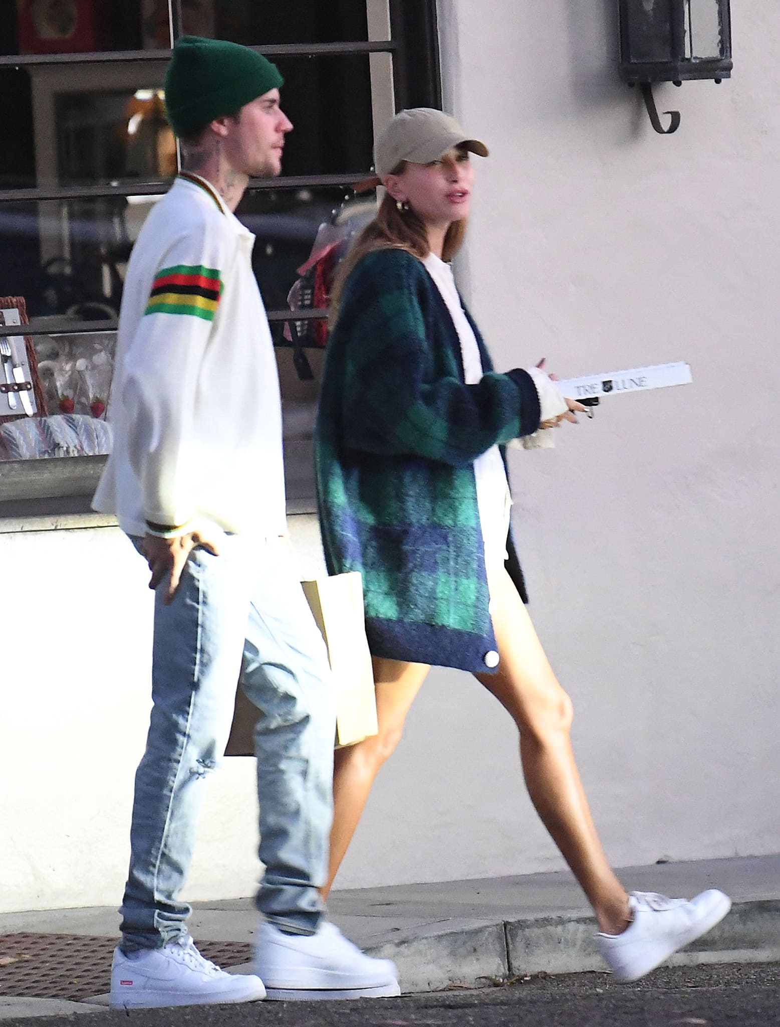 Hailey Bieber layers a plaid Alessandra Rich brushed-knit mohair blend cardigan over her casual outfit