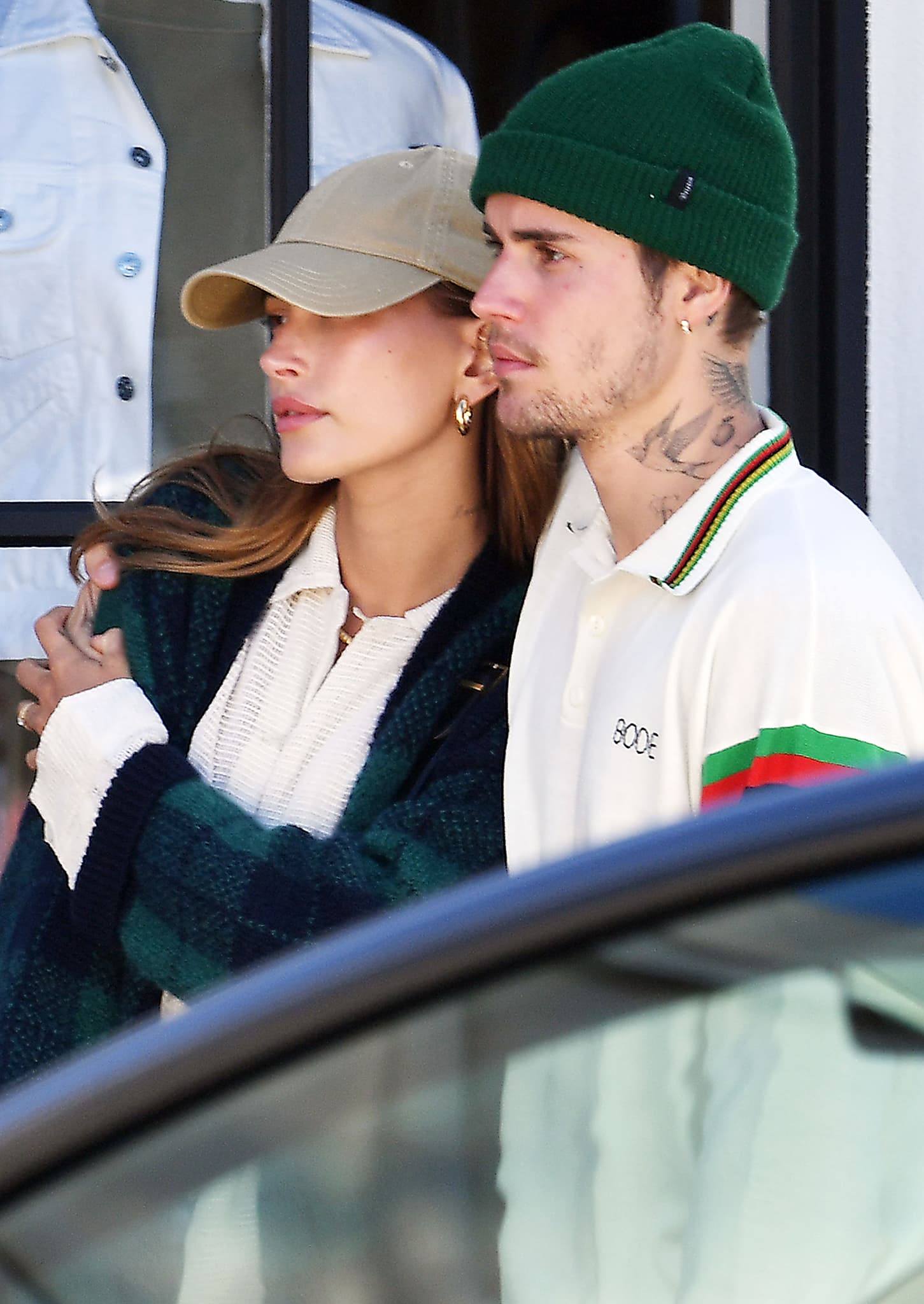 Hailey Bieber keeps things low-key with a beige cap as she cuddles her husband