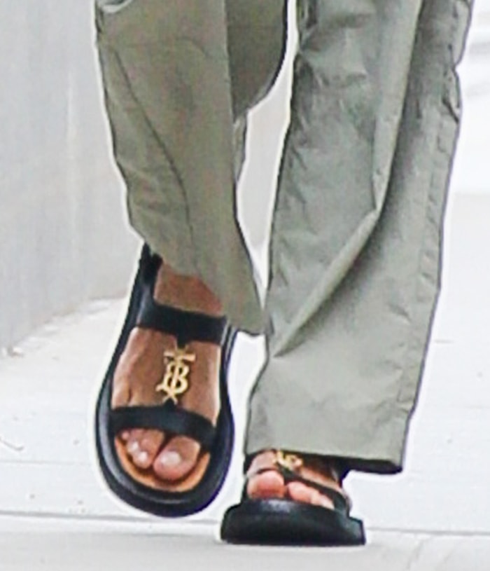 Irina Shayk completes her chic and sexy casual outfit by showing off her feet in Burberry logo-plaque sandals