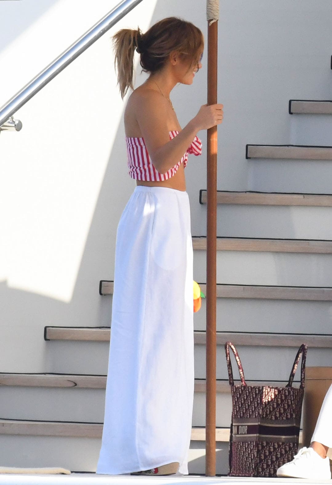 Jennifer Lopez pairs her bandeau top with flowing white pants