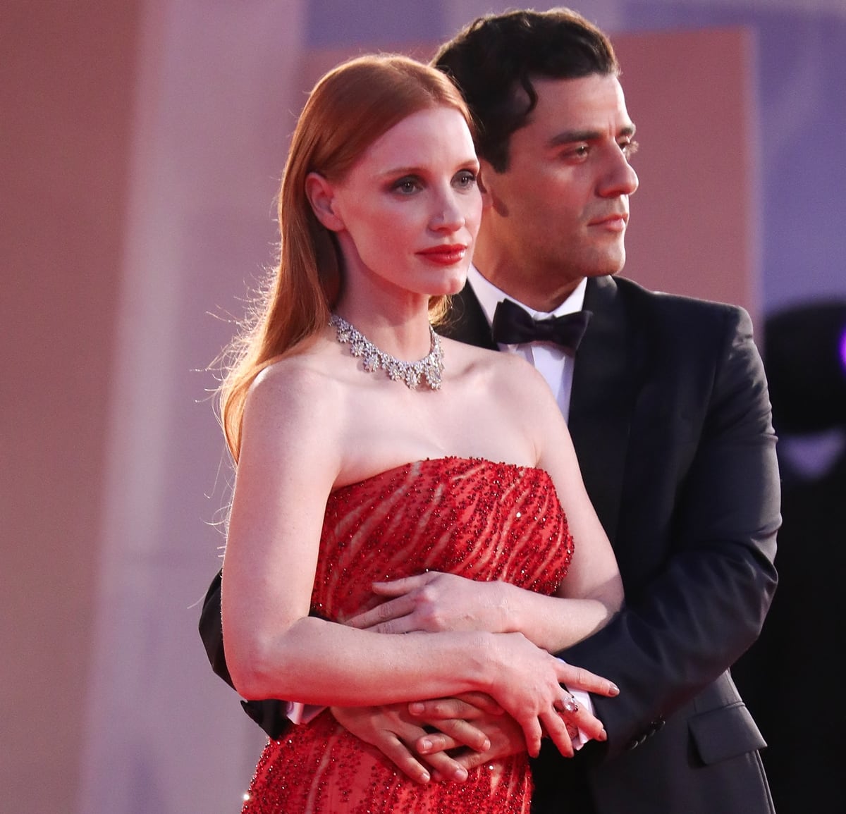 Jessica Chastain and Oscar Isaac with their arms wrapped around each other at the premiere of Scenes from a Marriage, which is a modern adaptation of Ingmar Bergman's classic Swedish series