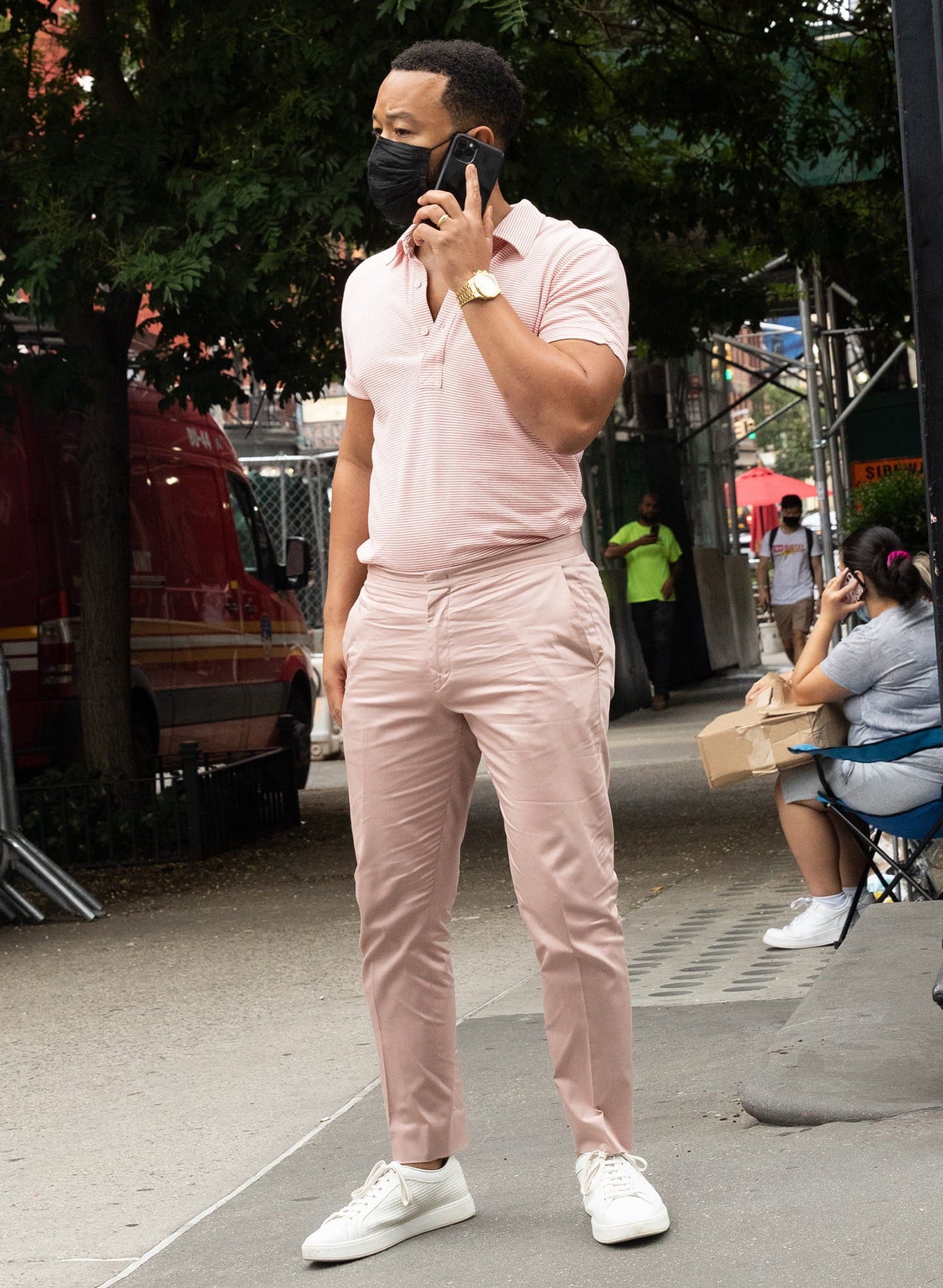 John Legend looks handsome in a pink polo shirt with matching pink pants and white shoes