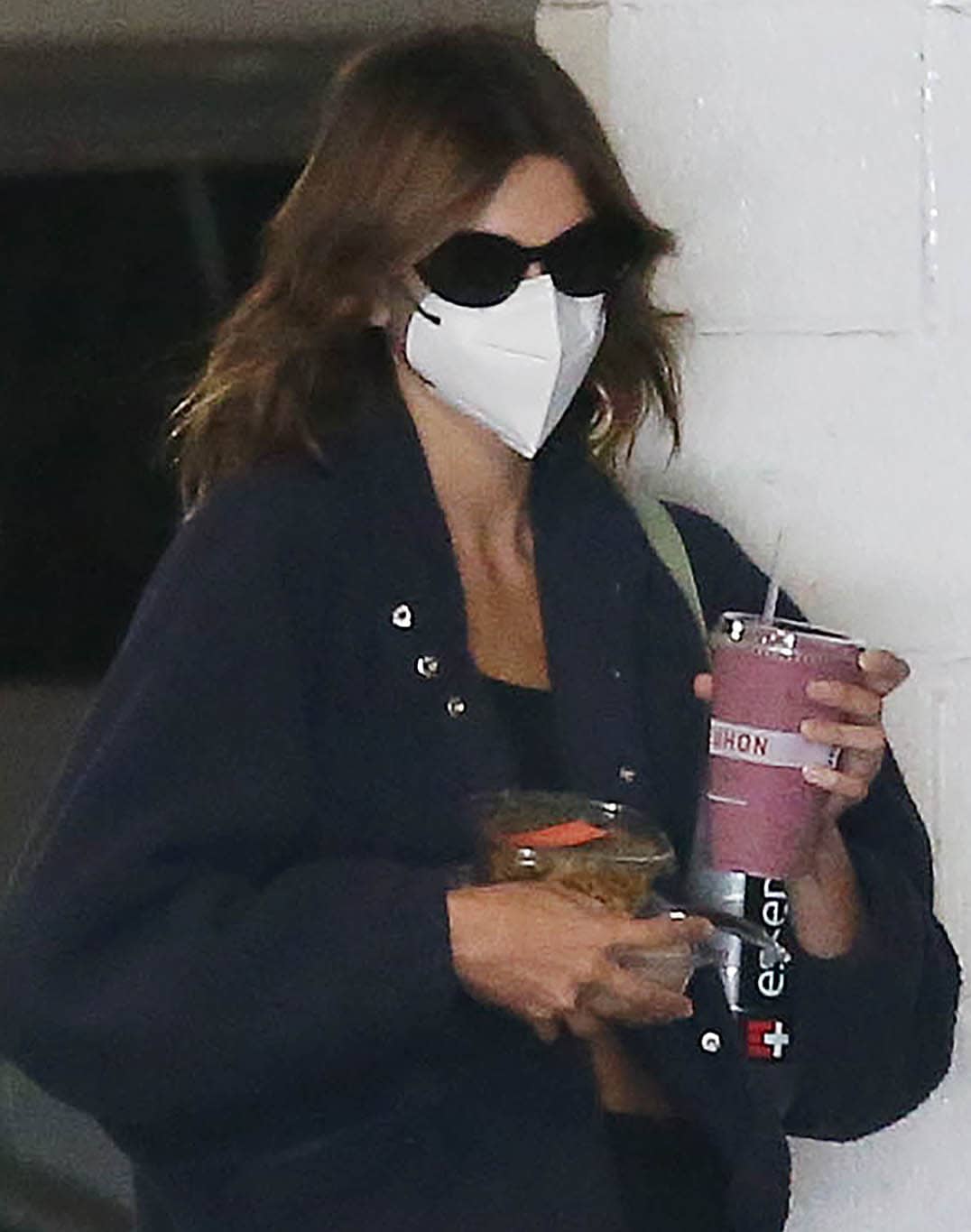 Kaia Gerber stays low-key with her Celine sunglasses and white face mask
