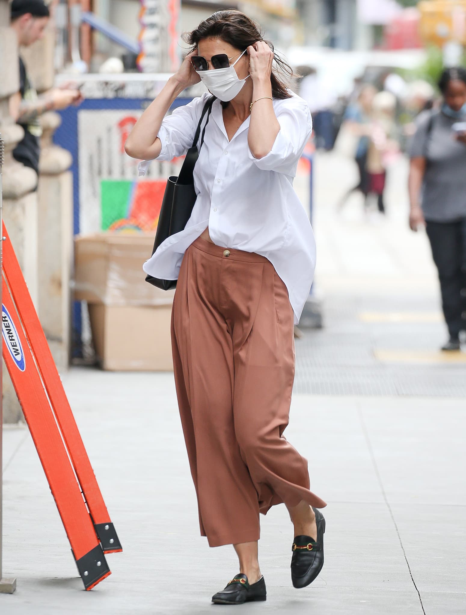 Showing to do the French tuck shirt style trick from Queer Eye, Katie Holmes steps out in New York City