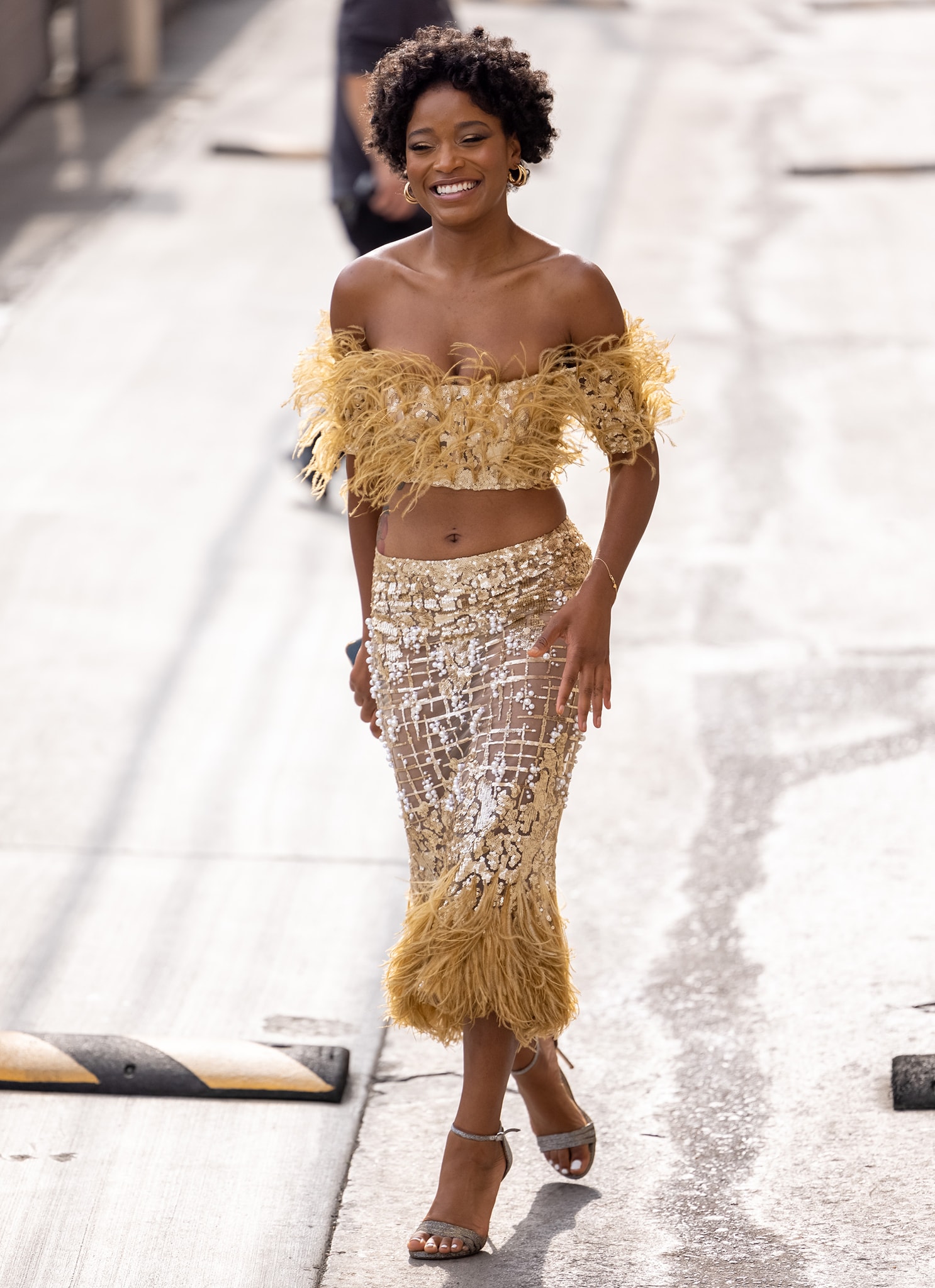 Keke Palmer puts her slim figure and belly button on display in a gilded Georges Chakra ensemble