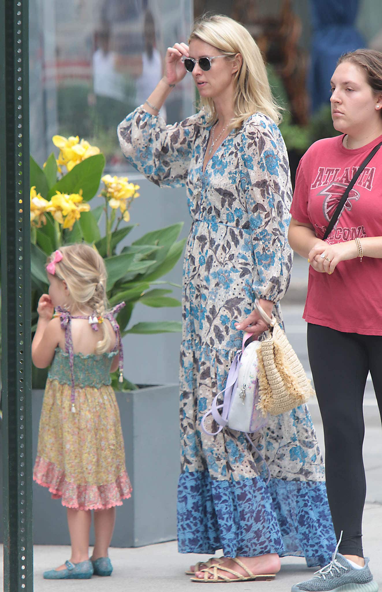 Nicky Hilton embraces effortless summertime chic in a floral maxi dress while strolling through NYC with her daughter, Lily Grace, on July 29, 2012
