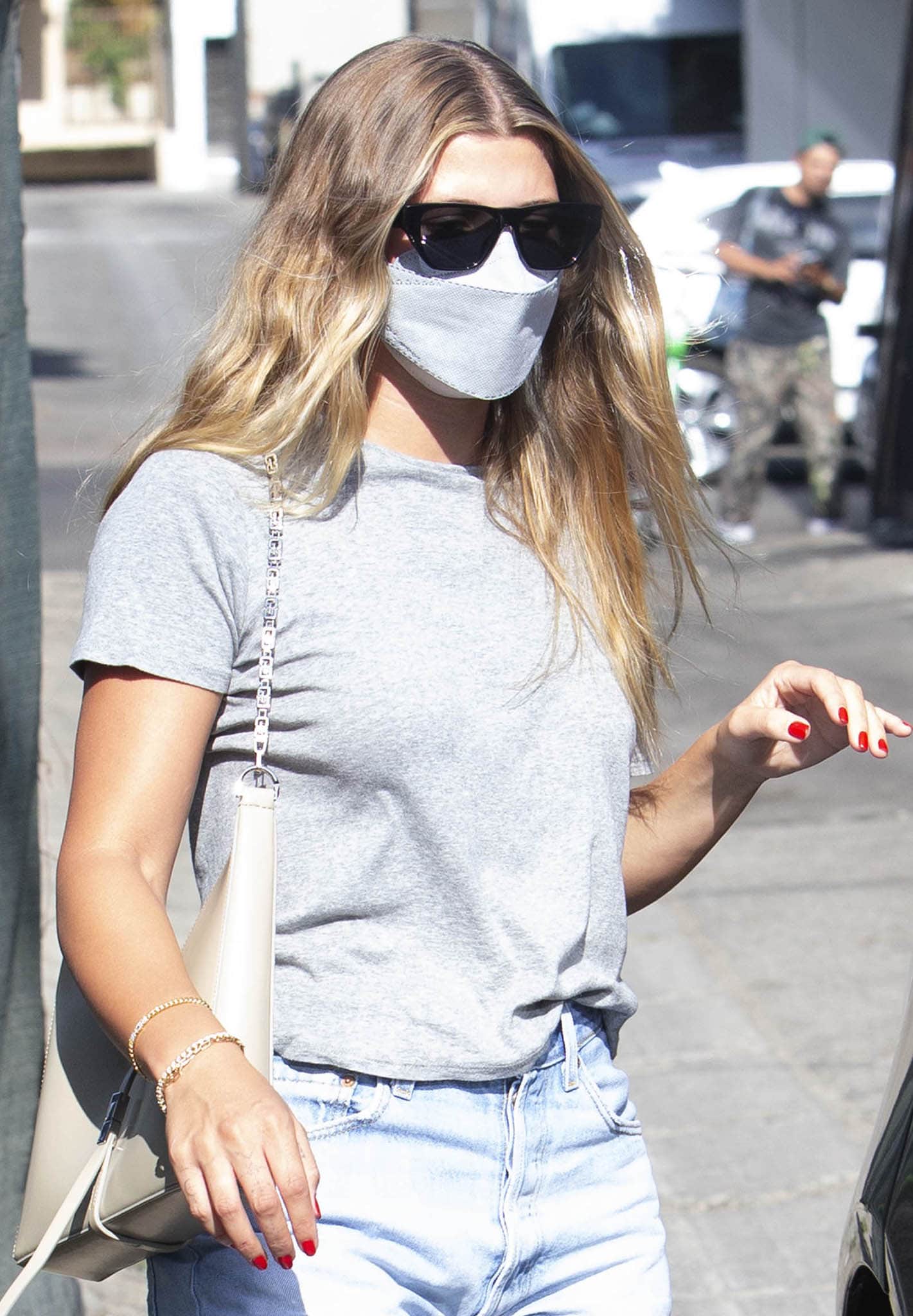 Sofia Richie wears red nail polish as she attempts to go incognito with Dior InsideOut 2 sunglasses and a gray face mask