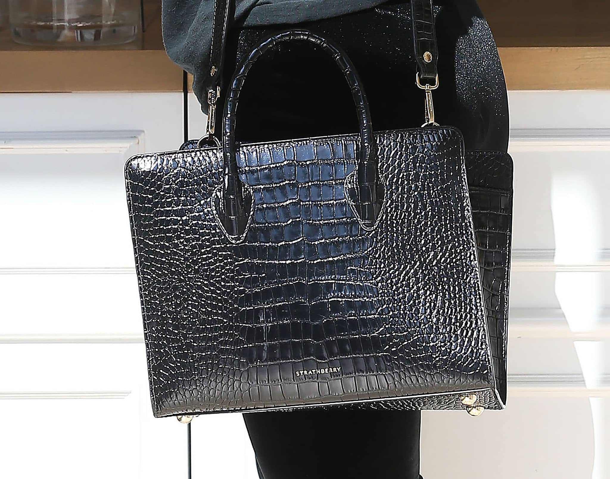 Addison Rae carries the Midi black croc-embossed leather tote from royal-approved bag label Strathberry