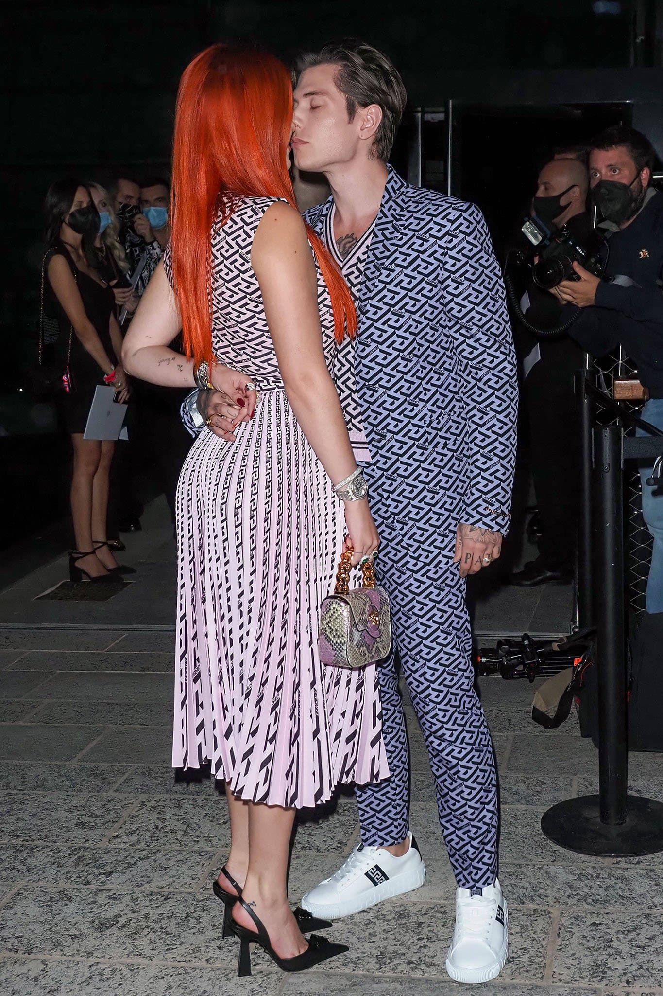 Bella Thorne and fiancé Benjamin Mascolo share a kiss at the Versace runway show during Milan Fashion Week on September 24, 2021