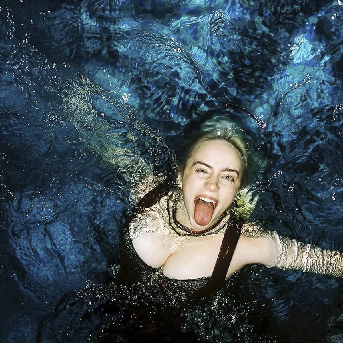 Billie Eilish celebrates her album Happier Than Ever by jumping into a pool with her clothes on