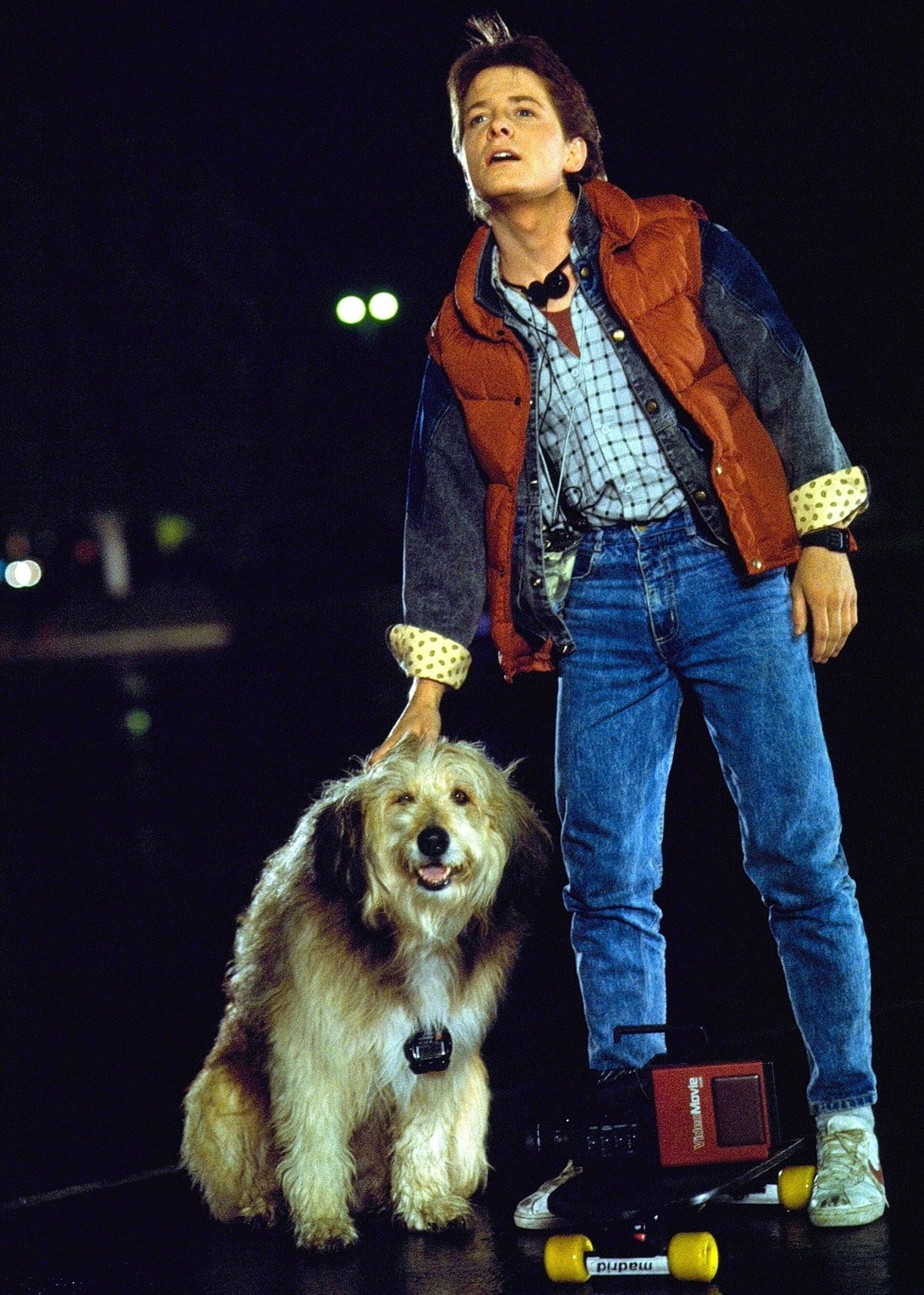 Michael J. Fox as Marty McFly wears blue Guess jeans with white Nike Bruin shoes and a down vest for the 1985 American science fiction film Back to the Future