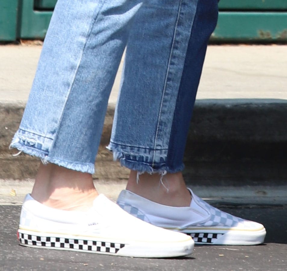 Gwen Stefani pairs her double denim outfit with Vans slip-on checkerboard sneakers